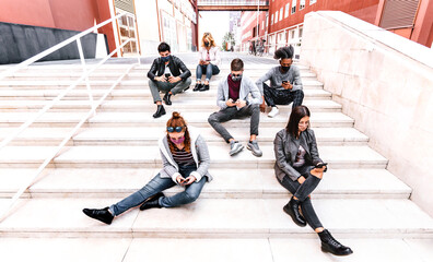 Urban milenial people using smart phones covered by face mask on Covid second wave - Worried guys...