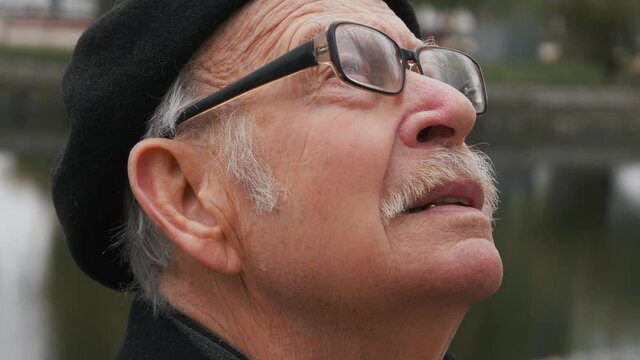 close up portrait of handome old man looking up praying exploring spirituality contemplating future