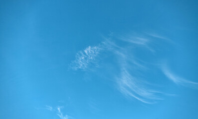 Beautiful evening blue sky, with white cirrus clouds of different shapes