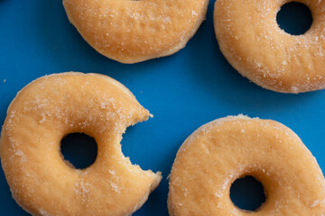 Bitten donut on blue background