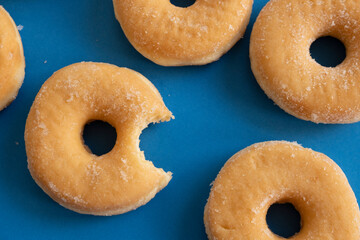 Bitten donut on blue background
