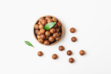 Bowl of macadamia nuts on a white background. Top view.