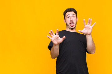 young man feeling terrified, backing off and screaming in horror and panic, reacting to a nightmare