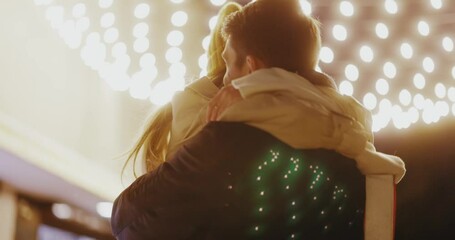 Young couple stand hugging outdoors. Boyfriend making holiday surprise to his woman celebrating together giving christmas present. Gift box. Slow motion - Powered by Adobe