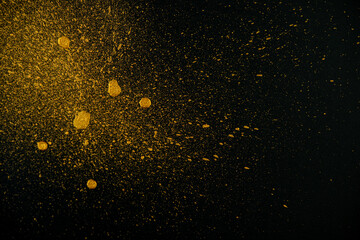 Fototapeta na wymiar Golden drops on a black background.