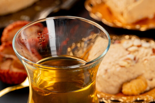Glass cup of tes and turkish desserts on table