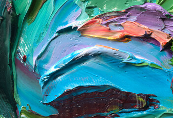 Close-up view of bright paint layered thickly. Strokes of paint