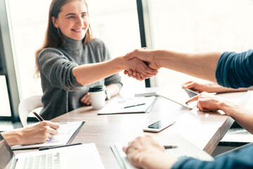 close up. young business woman shaking hands with her business partner.