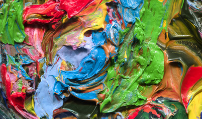 Close-up view of bright paint layered thickly. Strokes of paint