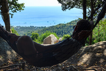 man swing in hammock and enjoy island view