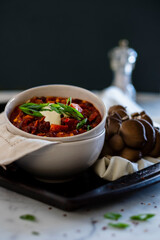Vegan chili bowl topped with cashew cream and green onions. 
