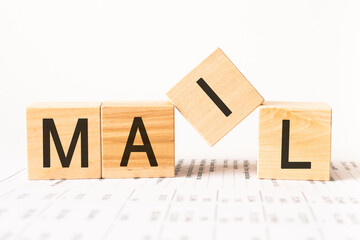 Word mail. Wooden small cubes with letters isolated on white background with copy space available.Business and finance concept