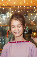 Portrait of a little girl with closed eyes and a dreamy smile waiting for Christmas