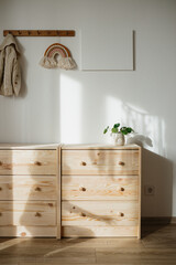 Part of children room with wooden chest of drawers