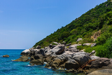 small green natural island view, rock bay and blue water

