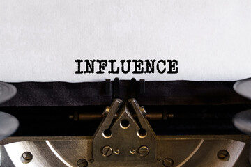 Vintage typewriter with typed text - INFLUENCE, on a sheet of paper