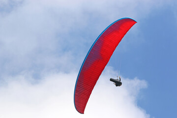 Paraglider flying wing in a blue sky	