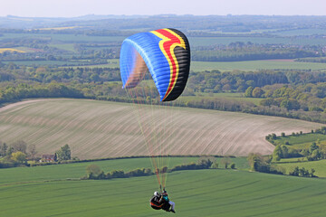 Tandem Paraglider flying at Combe Gibbet, England	