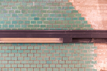 Green tiles on a building site with brown handrail