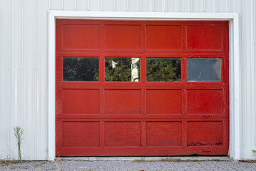 Red garage door with windows and handles