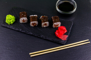 Sushi maki rolls with tuna on black slate