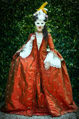 Obraz premium A Georgian woman wearing a silk robe a la Francaise and walking in a garden