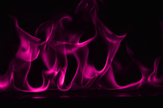 Close-up Of Purple Smoke Against Black Background