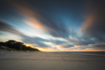 Obraz premium Baltic Sea in sunrise. Moving waves splashing in the coast