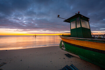 Fishing boat on the beach in Orlowo before sunrise, Gdynia. Poland