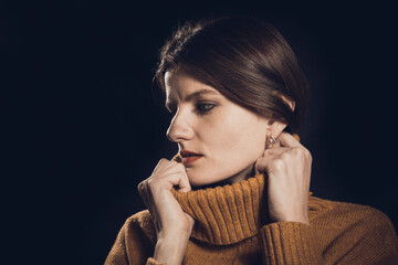 Studio portrait of young beautiful woman dressed in sweater