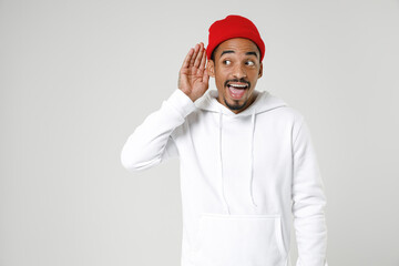 Excited young african american man 20s years old in basic casual streetwear hoodie try to hear you...