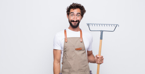 young man looking happy and goofy with a broad, fun, loony smile and eyes wide open