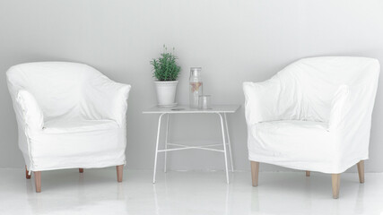 white chair in white meditation space with a table and a plant