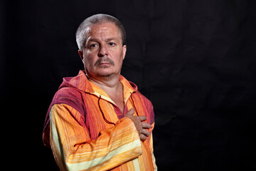 Obraz premium Middle aged man in bright orange clothe studio portrait