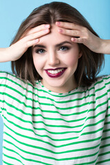 Beautiful fashionable young woman with bright makeup in a striped T-shirt.