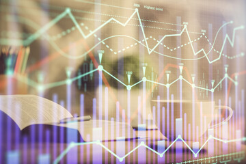 Multi exposure of forex graph drawing and desktop with coffee and items on table background. Concept of financial market trading