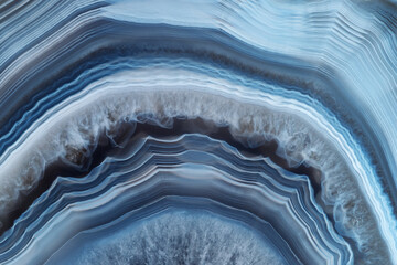 Full-screen close-up texture of translucent white-blue agate with a concentric pattern and ghostly...