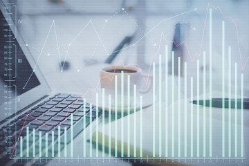 Double exposure of financial chart drawing and desktop with coffee and items on table background. Concept of forex market trading