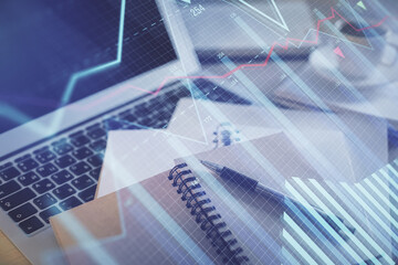 Fototapeta premium Double exposure of financial chart drawing and desktop with coffee and items on table background. Concept of forex market trading