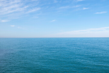 Blue ocean panorama with wave, calm sea and sky with clouds