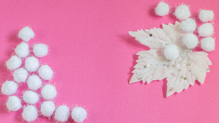 Decorative white fluffy snowflakes and maple leaf on the pink . Christmas background for greeting card or any your purposes.