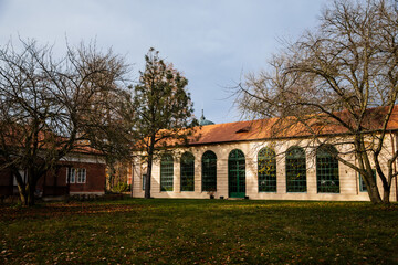 Classic style castle greenhouse with large wooden green windows, Romantic baroque chateau in sunny autumn day, Veltrusy Rococo castle, Central Bohemia, Czech republic