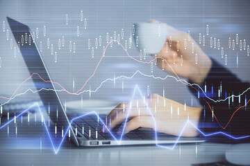 Double exposure of businesswoman hands typing on computer and forex graph hologram drawing. Financial analysis concept.