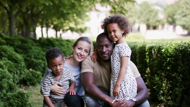 Multiracial family on walk in public park.