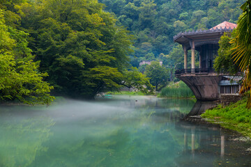 Beautiful landscape with old pavilion on the water