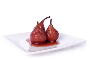Fresh Dutch poached Pears (stoofpeertjes: Gieser Wildeman) in red wine with cinnamon and clove,  on white plate. Glazed fruit, isolated an a white background.