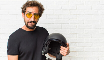 young man feeling clueless, confused and uncertain about which option to pick, trying to solve the...