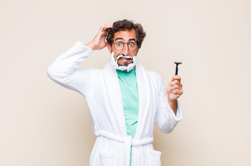 young man feeling stressed, worried, anxious or scared, with hands on head, panicking at mistake