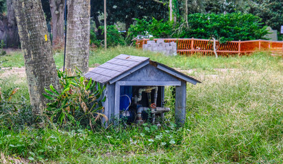 Fototapeta na wymiar Small Pump House in Rural Lawn