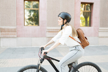 Profile of a businesswoman riding a bike to work